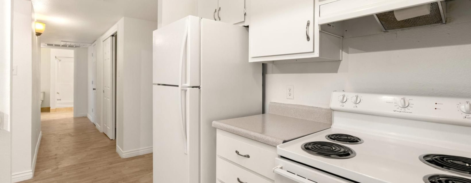 a kitchen with white cabinets