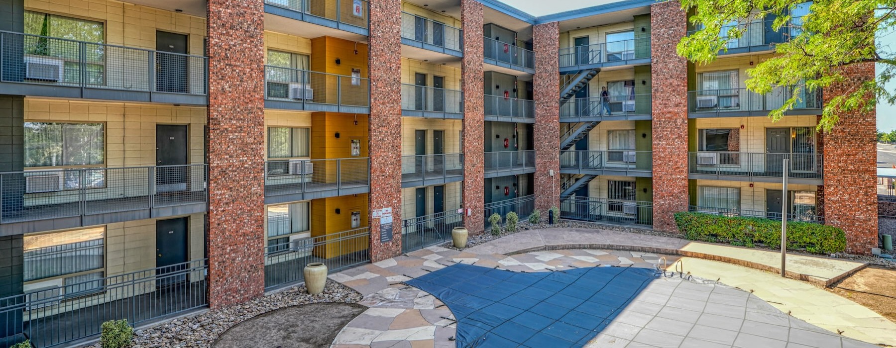 courtyard with a pool and balconies