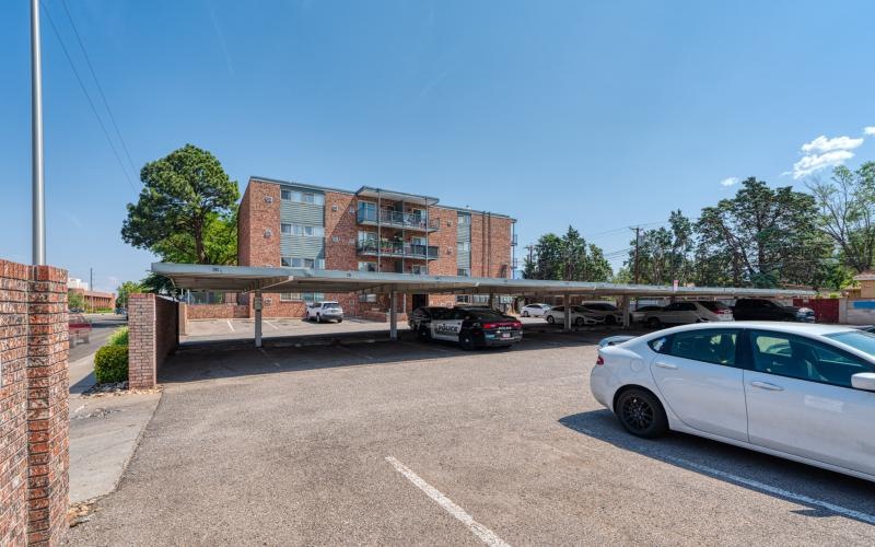a parking lot with cars and a building in the background